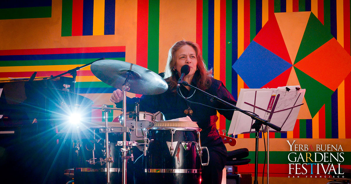 Photo of musician Annete Aguilar playing the drums