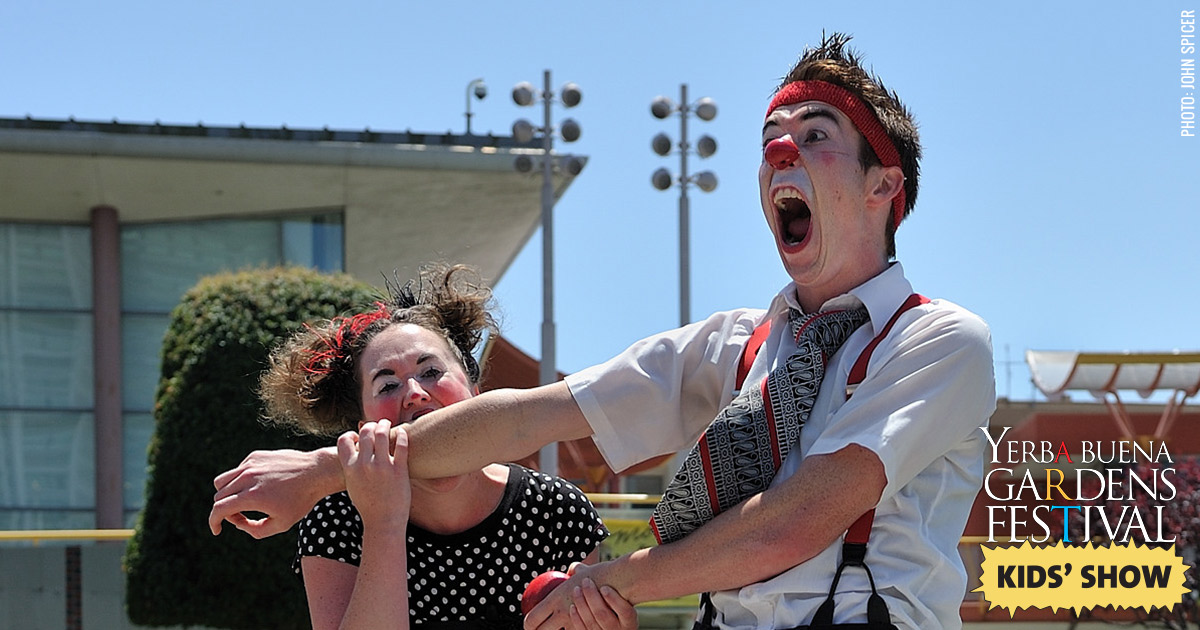 Photo of Pi Clowns by John Spicer: one clown biting another's arm