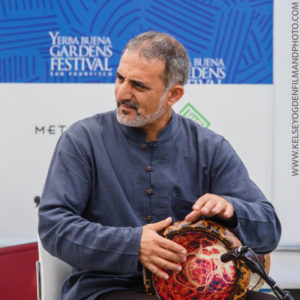 Photo of musician Faisal Zedan playing a hand drum. Photo by www.KelseyOgdenFilmAndPhoto.com