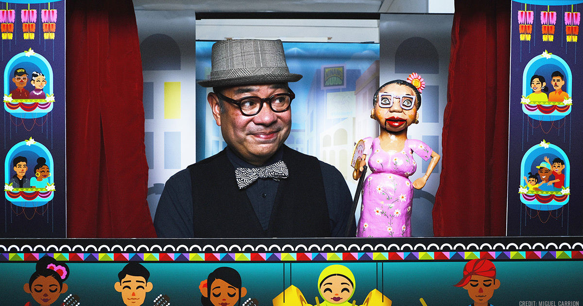 Tito Ramon and a puppet smiling in the puppet box