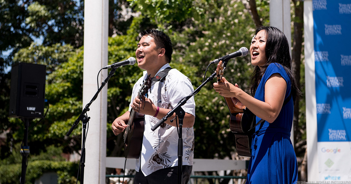SF Uke Jam leaders Cynthia Lin and Ukelenny singing and playing ukulele together on the YBG Festival stage