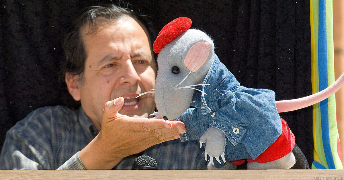 Puppeteer Joe Leon performing with a mouse puppet