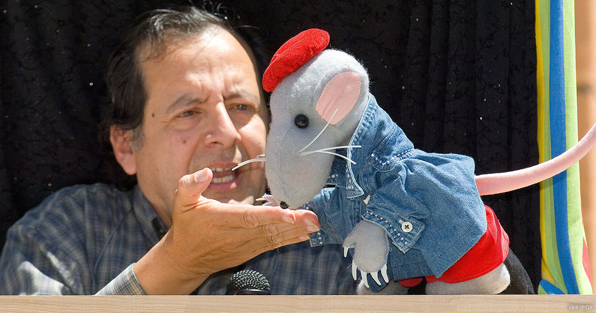 Puppeteer Joe Leon performing with a mouse puppet