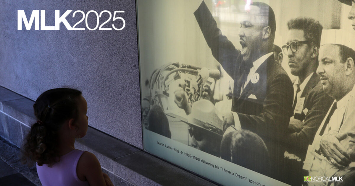 Photo of a child looking at large illuminated image of Dr. Martin Luther King Jr.