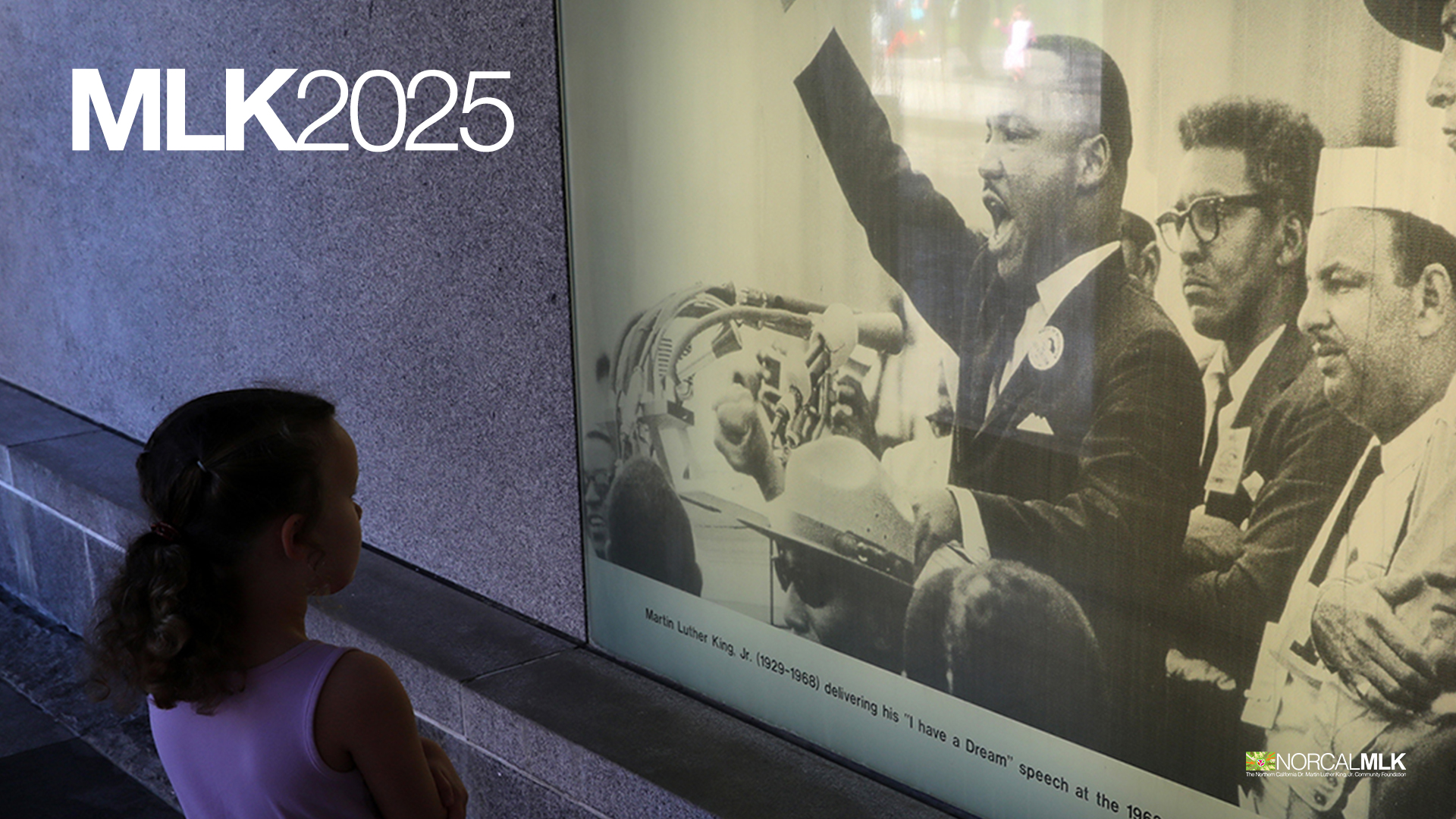 Photo of a child looking at large illuminated image of Dr. Martin Luther King Jr.