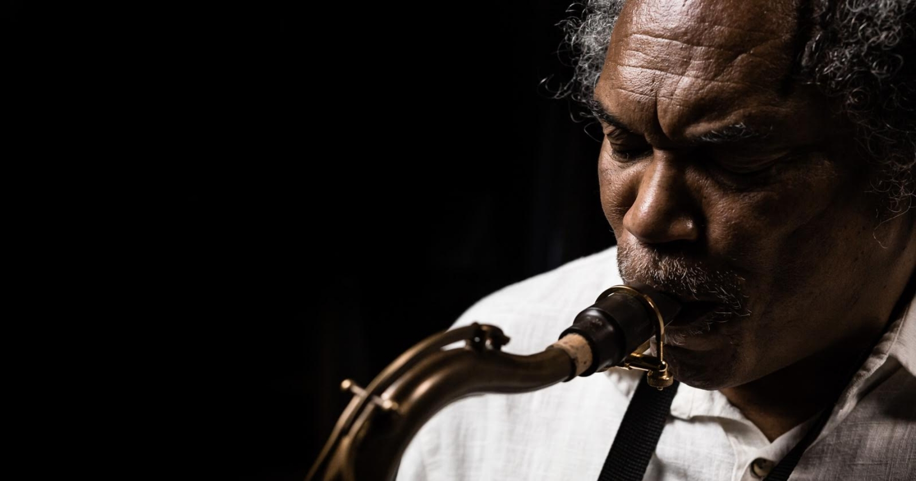 a close-up of Richard playing his saxophone